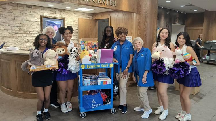 University High School cheer squad donating toys to children at Providence Hospital
